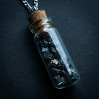 Anandham silver — macro with cool rim light on charcoal